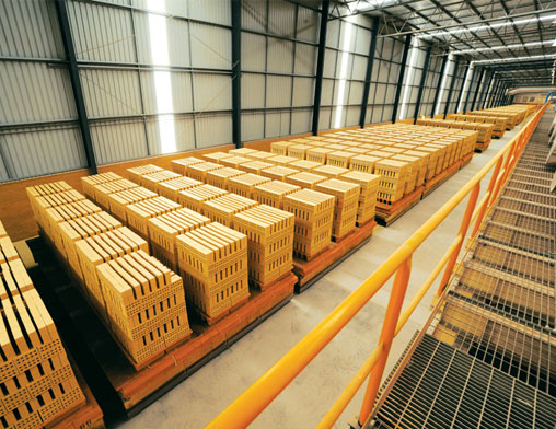 A photo of a warehouse full of pallets of bricks