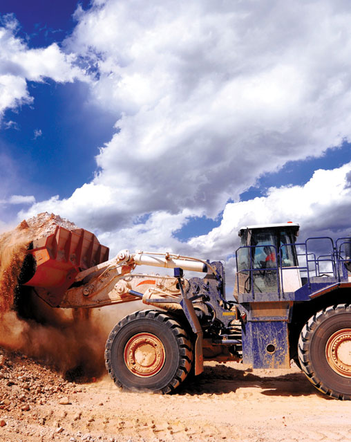 A picture of an earthmover with a scoop full of earth